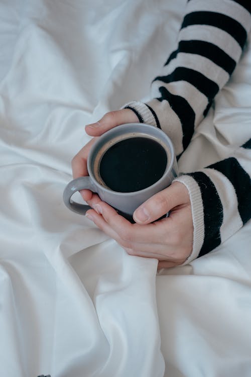 Free Woman Holding a Cup of Black Coffee  Stock Photo