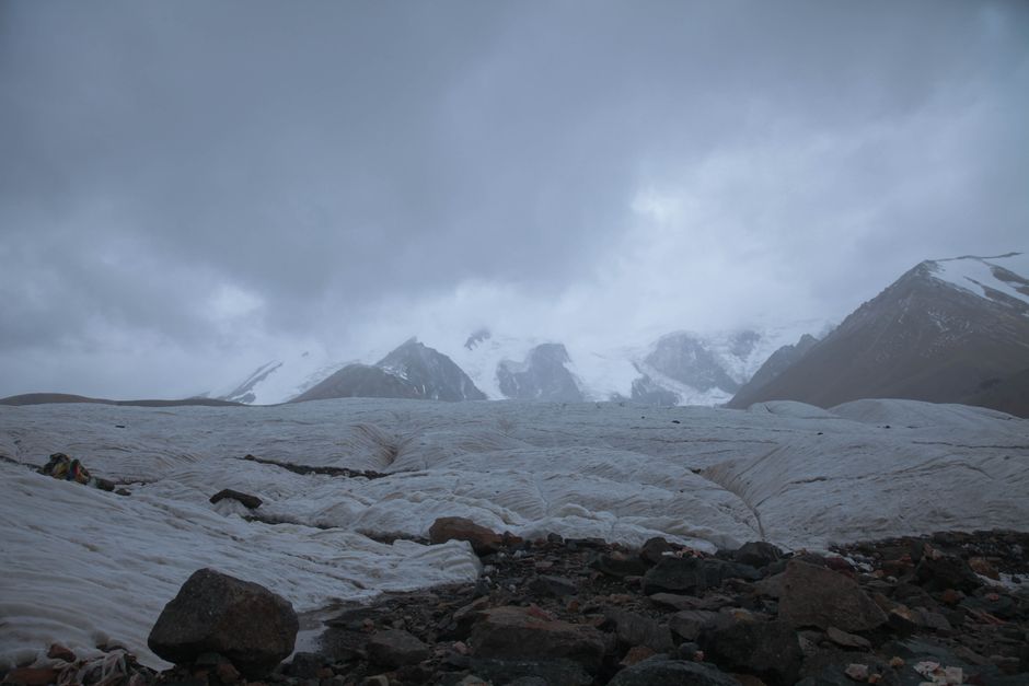Broad Peak Expedition Pakistan - Dramatic winter landscape featuring snowcapped mountains and glacier under a moody sky.