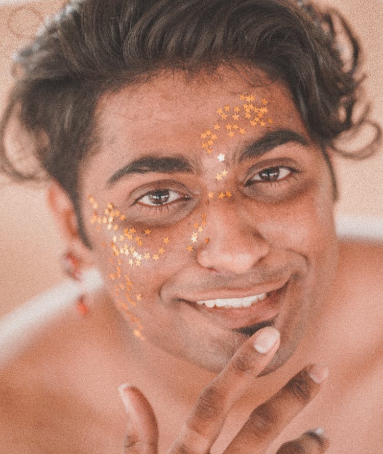 Man With Face Decorated With Golden Star Stickers