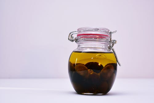Free Clear Airtight Canister With Brown Liquid Stock Photo