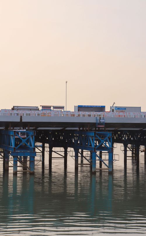 Free Tranquil view of a steel pier over calm waters at sunset, capturing reflections and a peaceful ambiance. Stock Photo