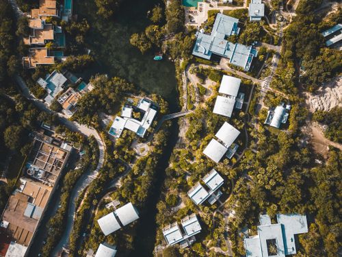 Free Stunning aerial view of a tropical resort in Playa del Carmen, showcasing lush greenery and vibrant architecture. Stock Photo