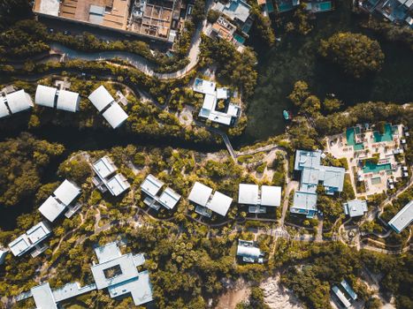 Drone shot capturing the lush greenery and modern architecture of a Playa del Carmen resort.