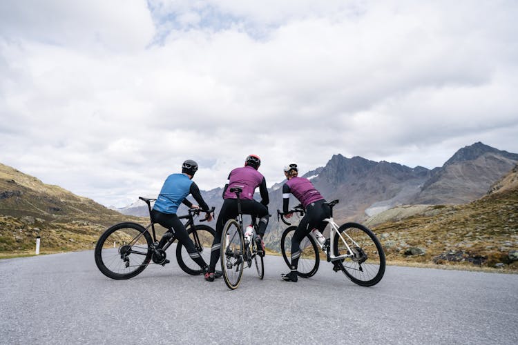 Group Of People On Bicycles On A Road