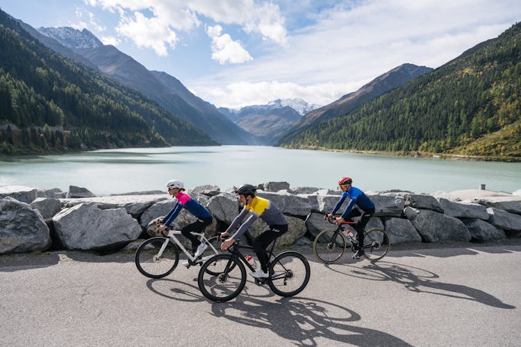 Woman And Men Riding Bicycles In The Mountains