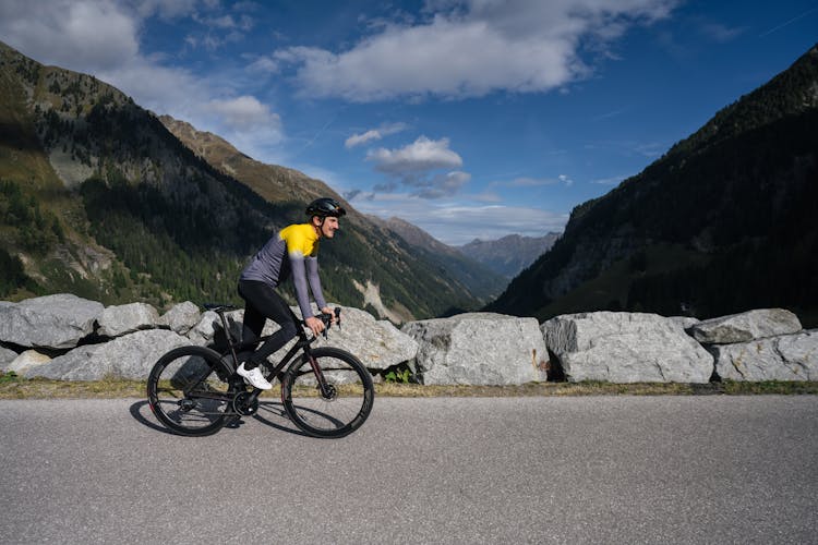 Man Riding A Bike On A Mountain Road