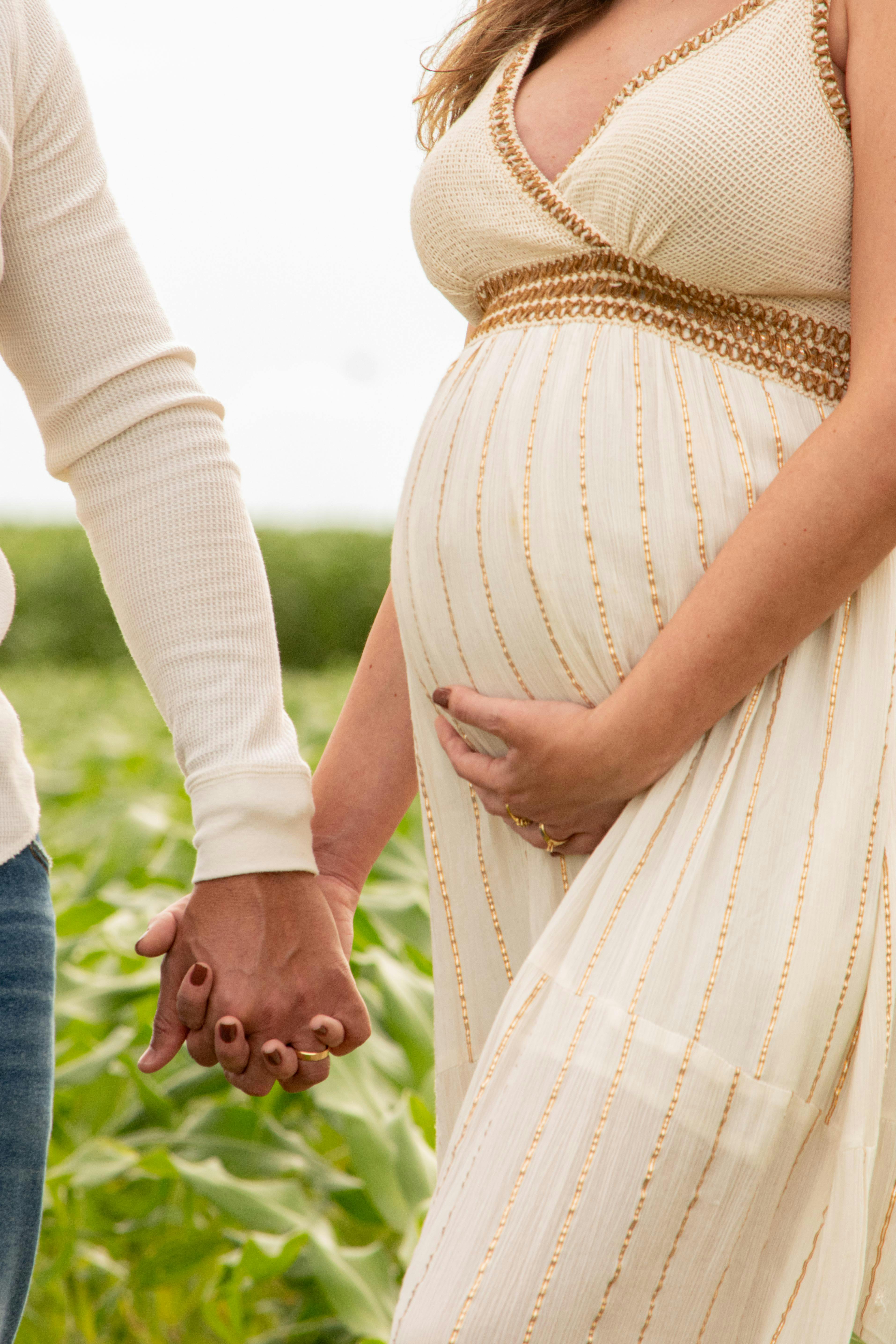 pregnant woman holding hands with a man