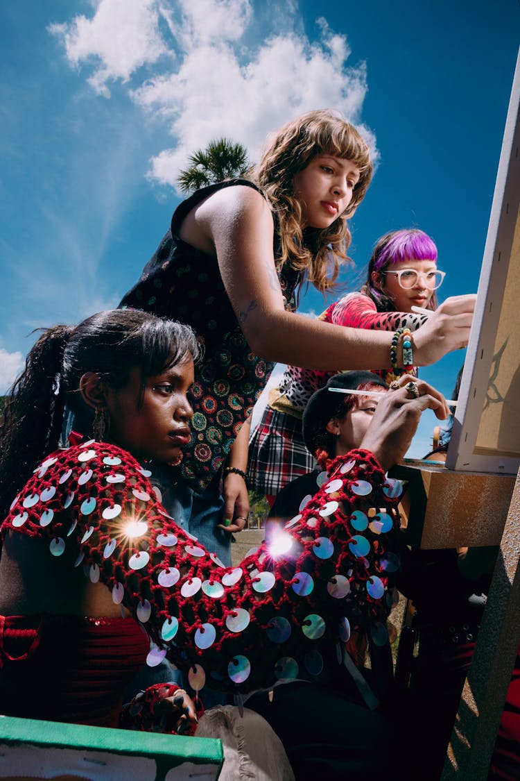 Group Of Girls Painting On Canvas 