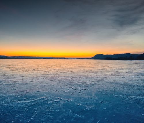 Free A breathtaking view of sunrise reflecting over the frozen Mississippi River in Weaver, Minnesota. Stock Photo