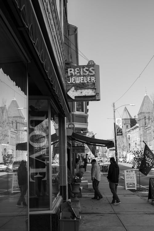 People Walking on Sidewalk on City Street