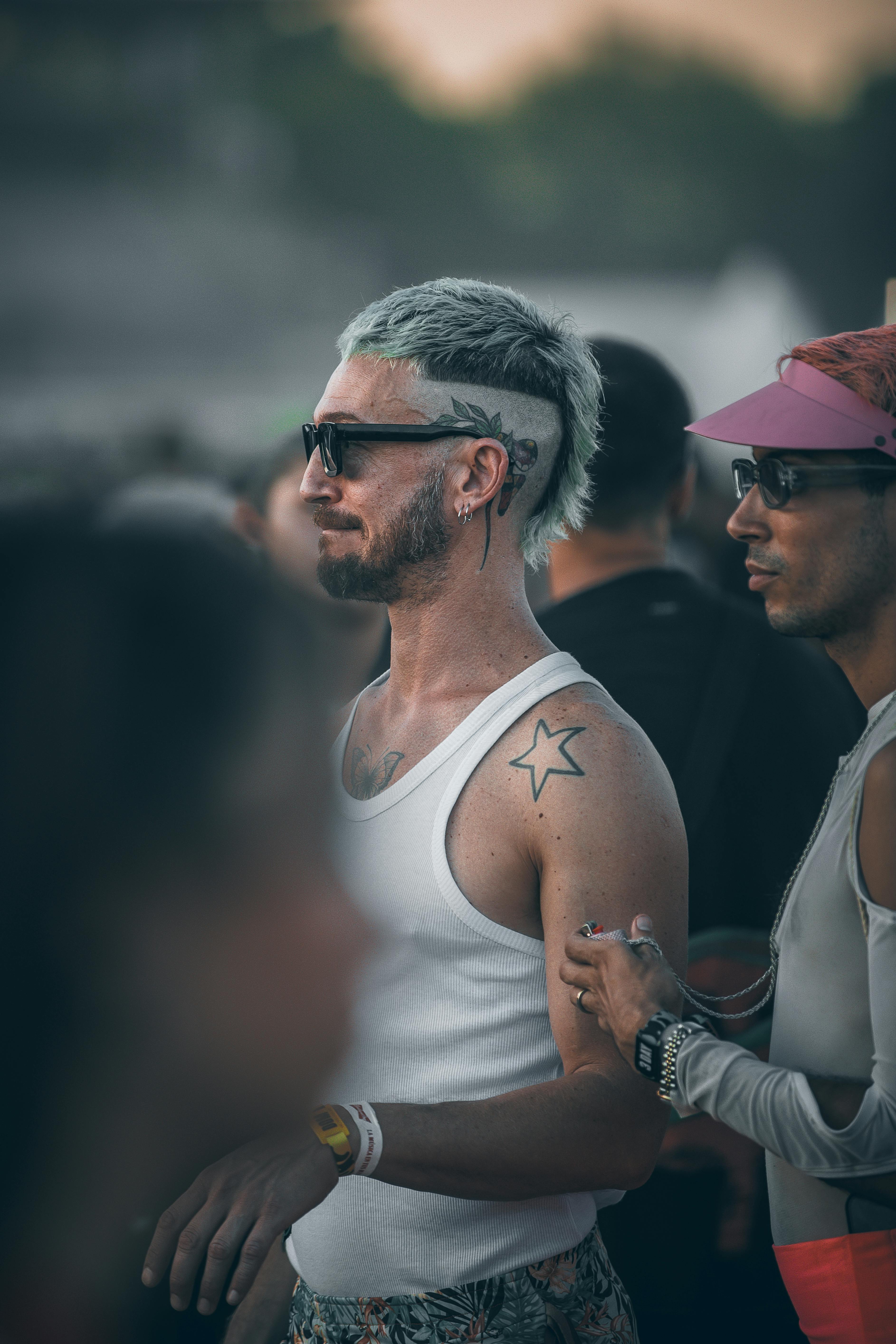 free photo of man with tattoos in the audience
