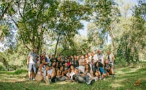 Group of People Posing under Trees in Park