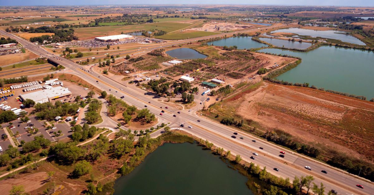 Aerial view of Fort Collins, CO showing roads, ponds, and fields in a rural setting.