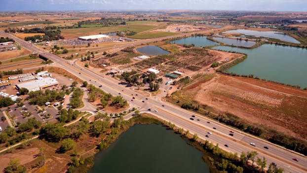 Aerial view of Fort Collins, CO showing roads, ponds, and fields in a rural setting.