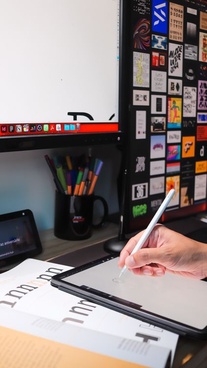 Working on a Tablet at a Computer · Free Stock Photo