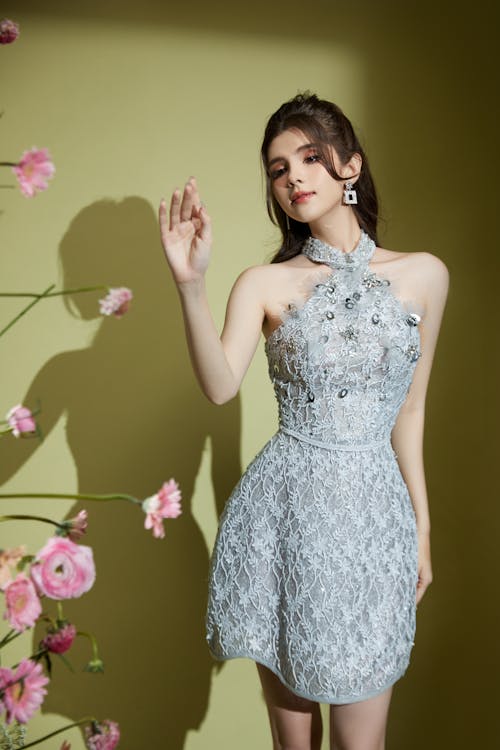 Woman in Gray Short Evening Dress Posing in Studio