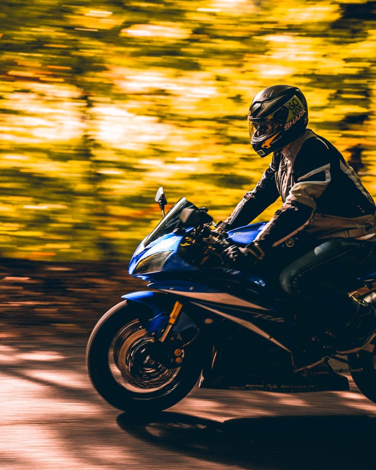 Man In Helmet Riding Motorbike In Forest