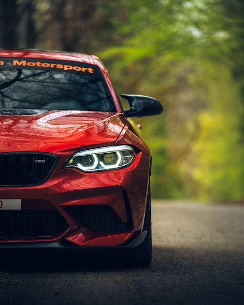 Red BMW M2 on Forest Road