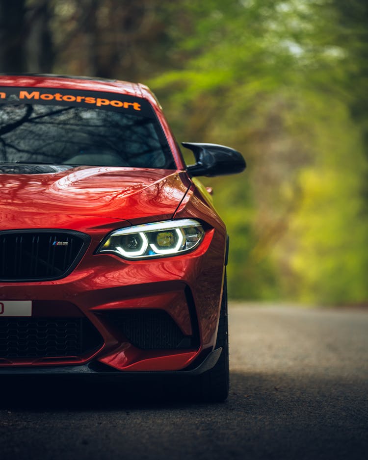 Red BMW M2 On Forest Road