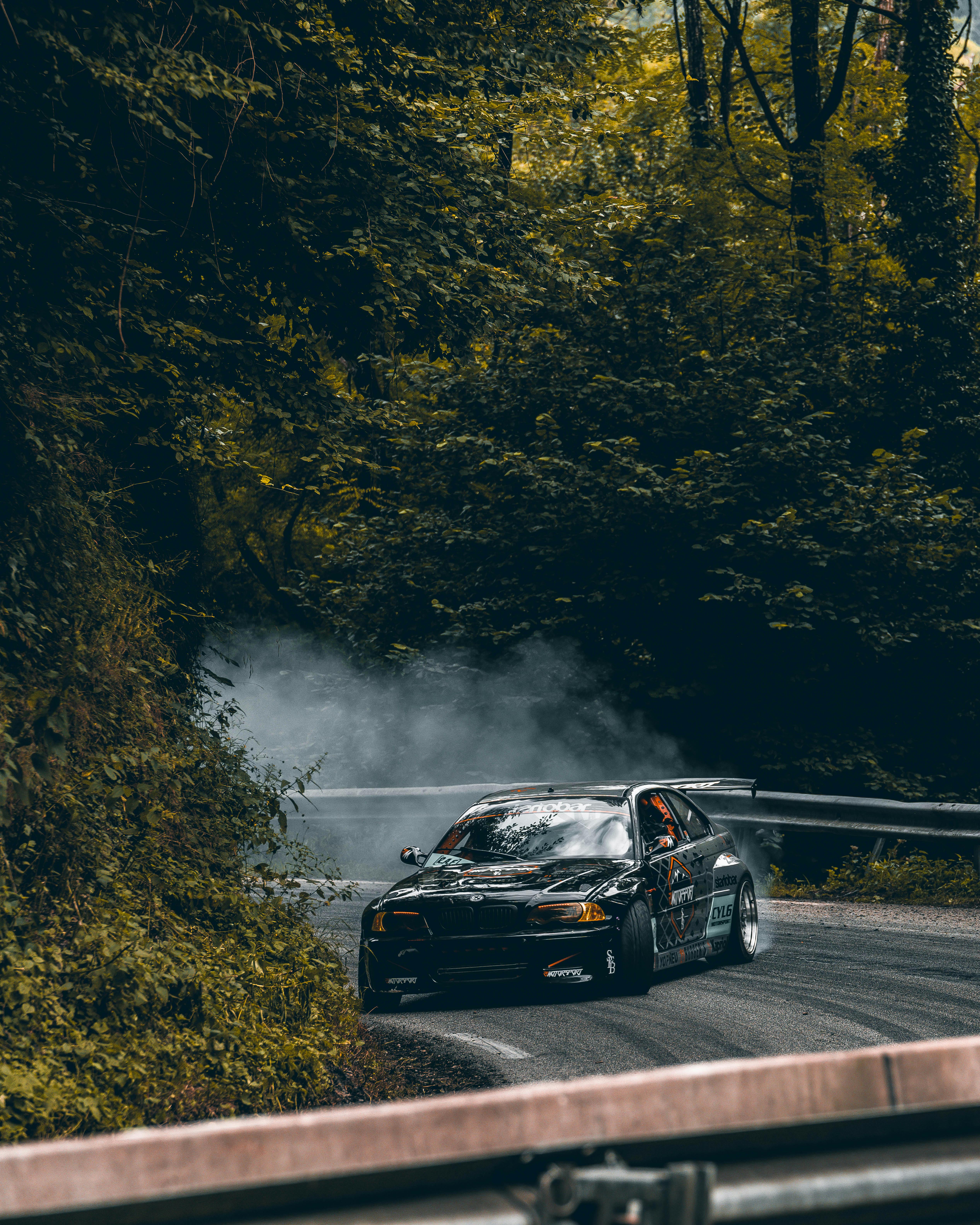 Race Car Drifting on Road through Forest · Free Stock Photo