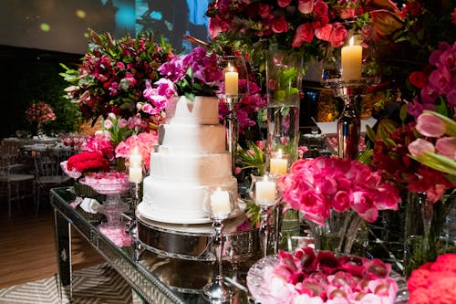 Wedding Cake on the Table Decorated with Pink Flowers