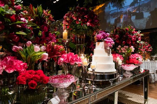 Wedding Cake on the Table Decorated with Pink Flowers