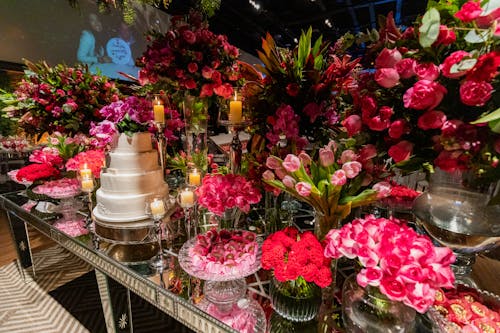 White Creamy Wedding Cake among Flowers Arrangement