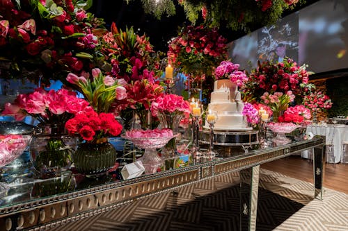 Wedding Cake on the Table Decorated with Pink Flowers