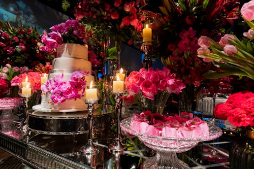 Wedding Cake on the Table Decorated with Pink Flowers
