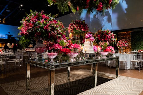 Dessert Table Decorated with Pink Flowers at a Banquet