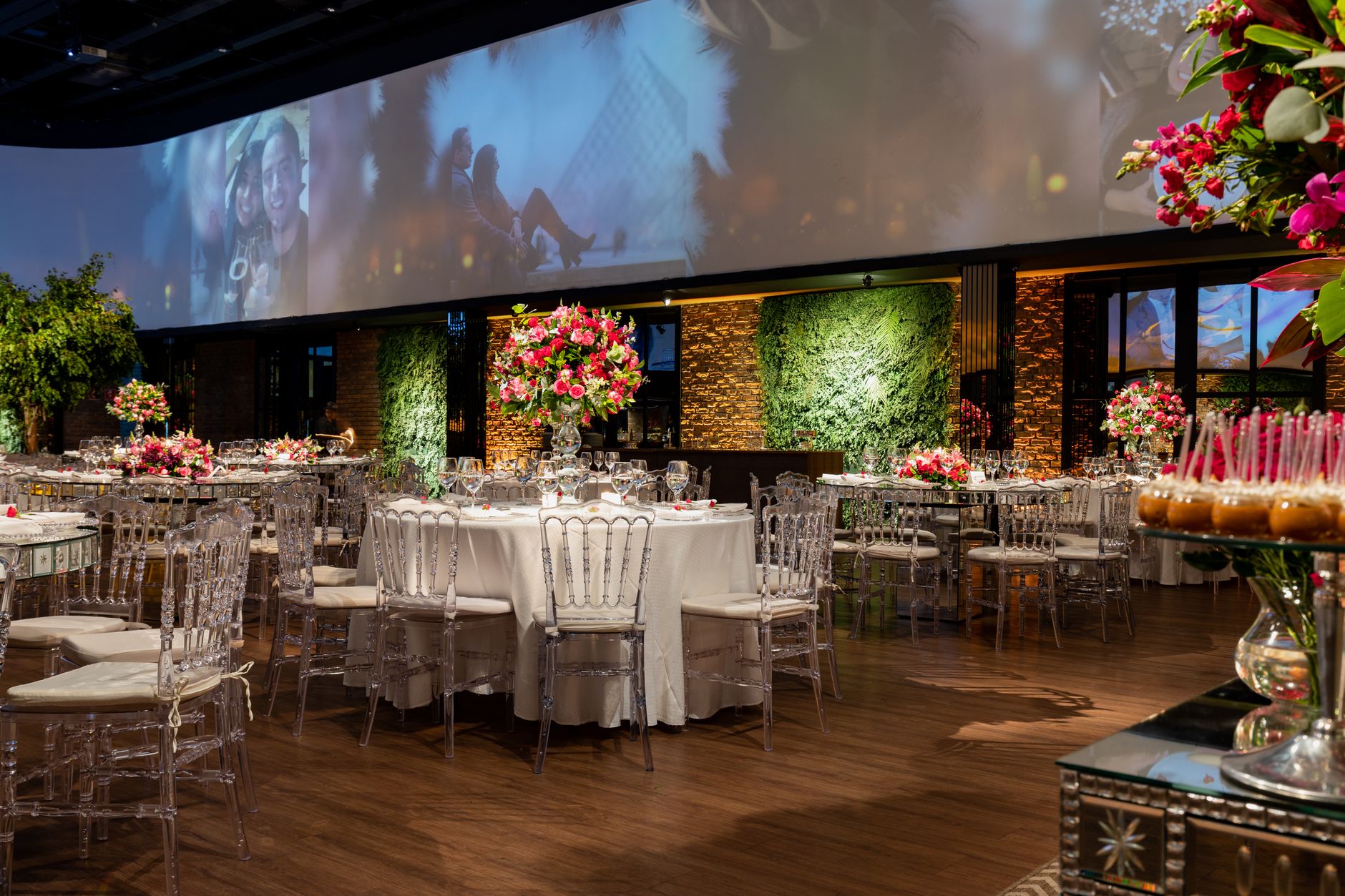 A beautifully decorated indoor event venue with vibrant floral arrangements and elegant seating.