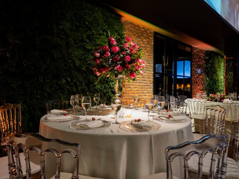 Banquet setup with round tables and pink floral arrangements