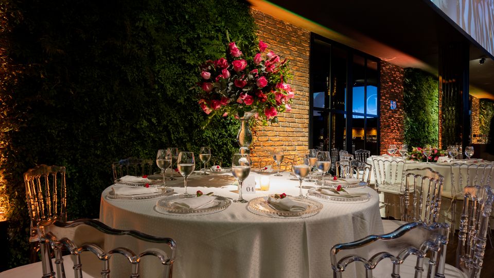 Signature banquet setup with round tables and pink floral arrangements