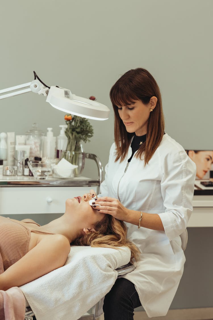 Cosmetologist Making Beauty Procedures To Woman In Salon