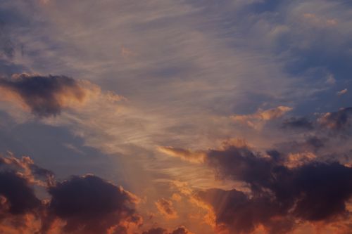 Free Stunning sunset with vibrant clouds and dramatic lighting in the sky. Stock Photo