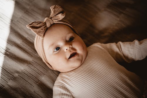 Baby Girl Lying on a Bed