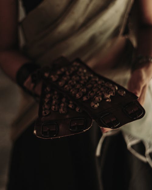 Close up of Standing Person Holding Black Items