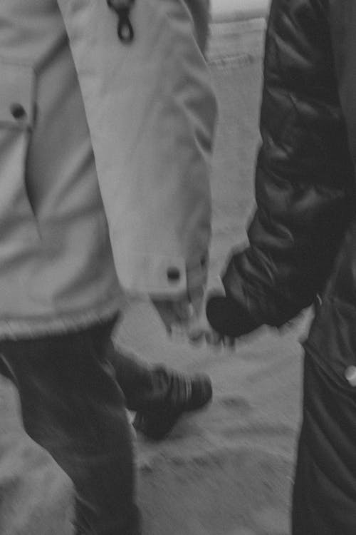 Blurry Black and White Picture of a Couple Holding Hands 
