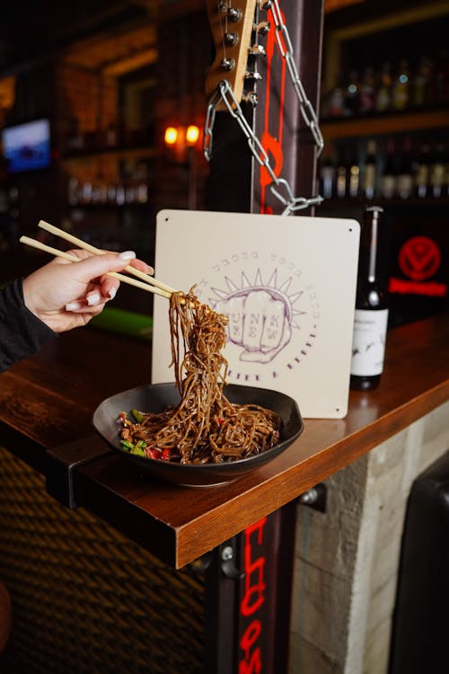 Meal with Noodles Eating with Chopsticks