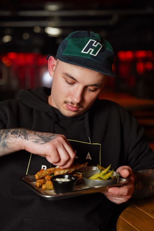 Free A young man savoring a gourmet meal in a cozy indoor restaurant. Stock Photo