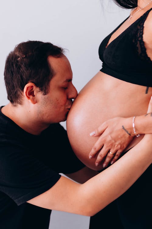 Man Kissing His Pregnant Partners Belly 