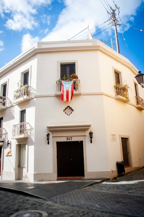 Facade of a Traditional Building with the Flag of Puerto Rico Hanging in the Window 