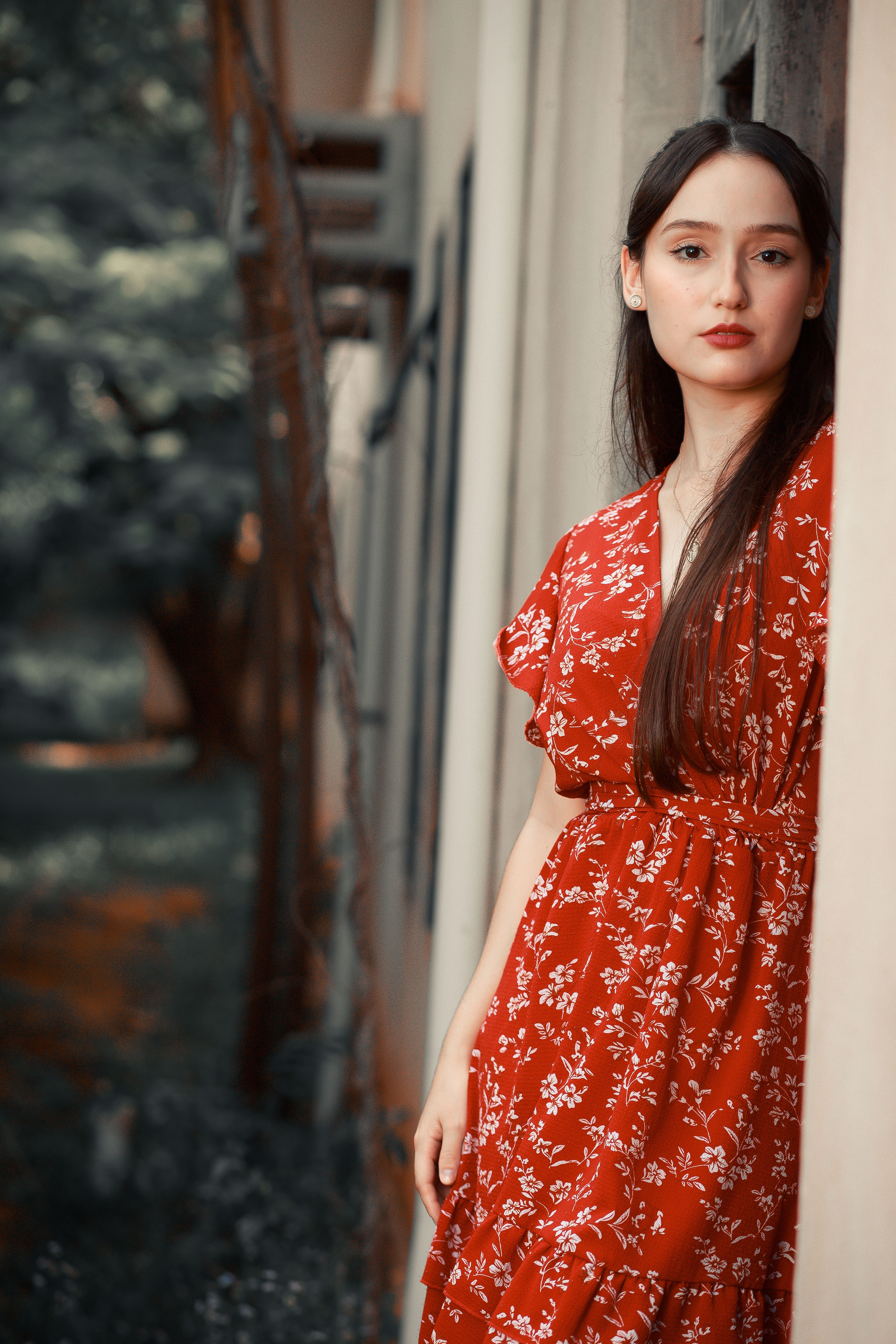 Woman in Red Dress Posing by Wall · Free Stock Photo