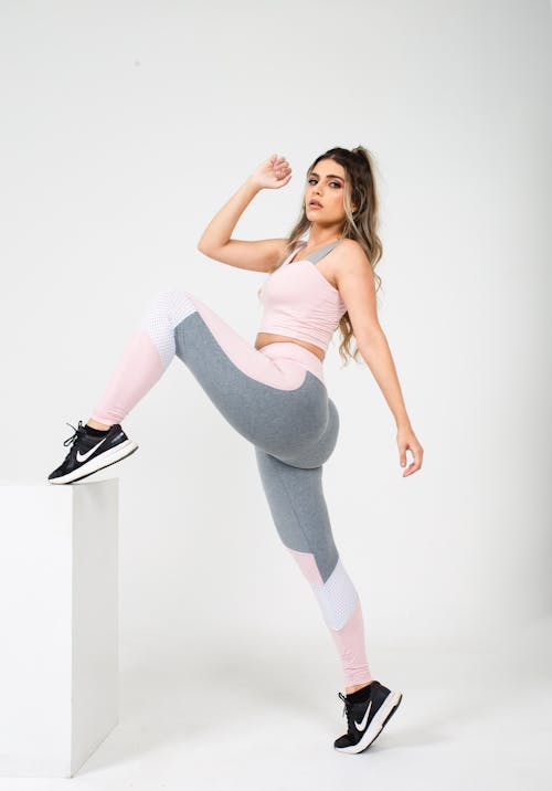 Free Young Woman in Sports Clothing Posing in Studio  Stock Photo