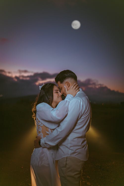 Young Couple Embracing Outdoors at Night