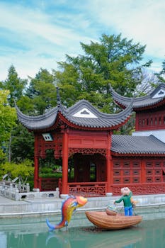 Serene Chinese pavilion surrounded by lush trees in a tranquil garden setting.
