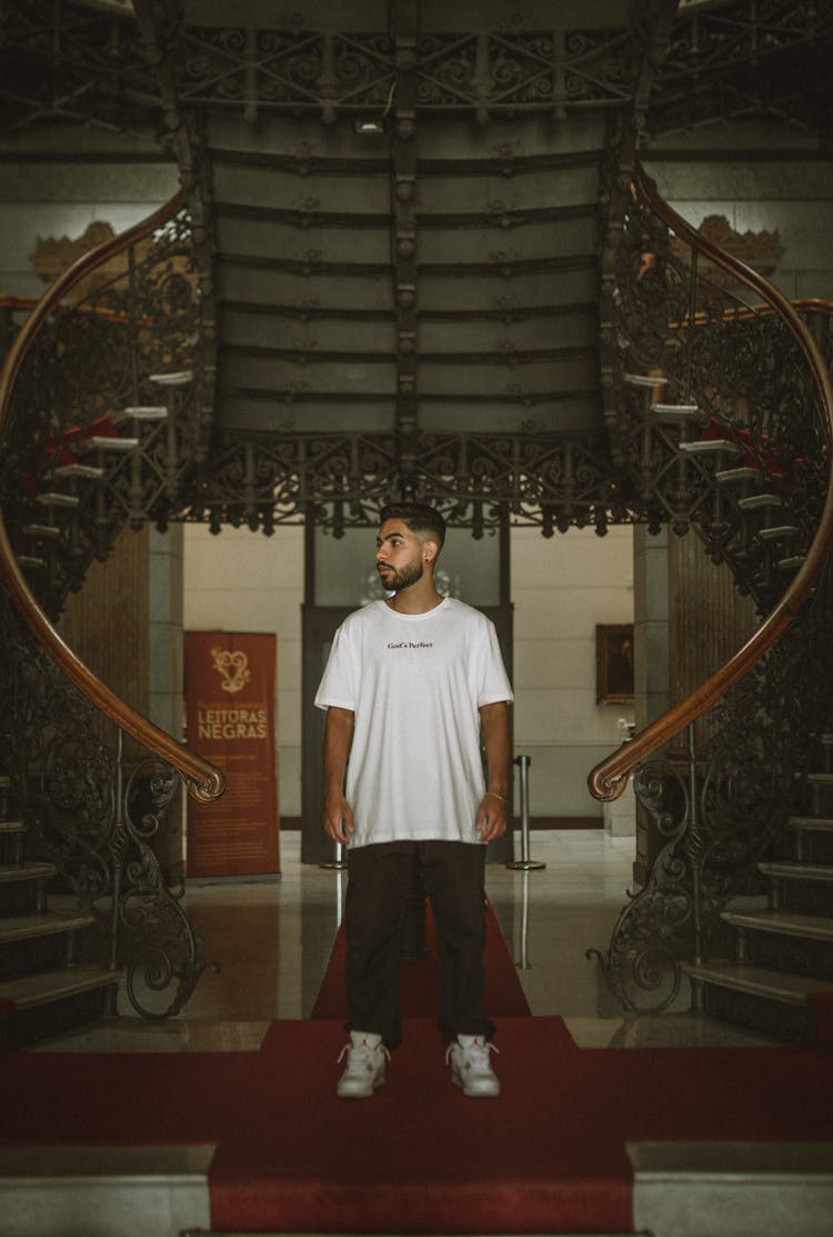 Young Man In Casual Clothes Standing In A Palace 