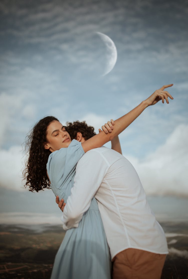 Young Couple Embracing Outdoors At Dusk