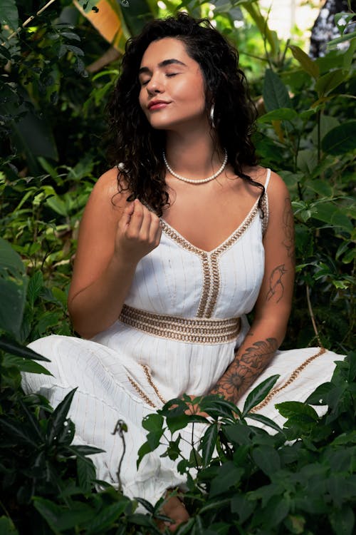 Content Woman Relaxing Between Plants