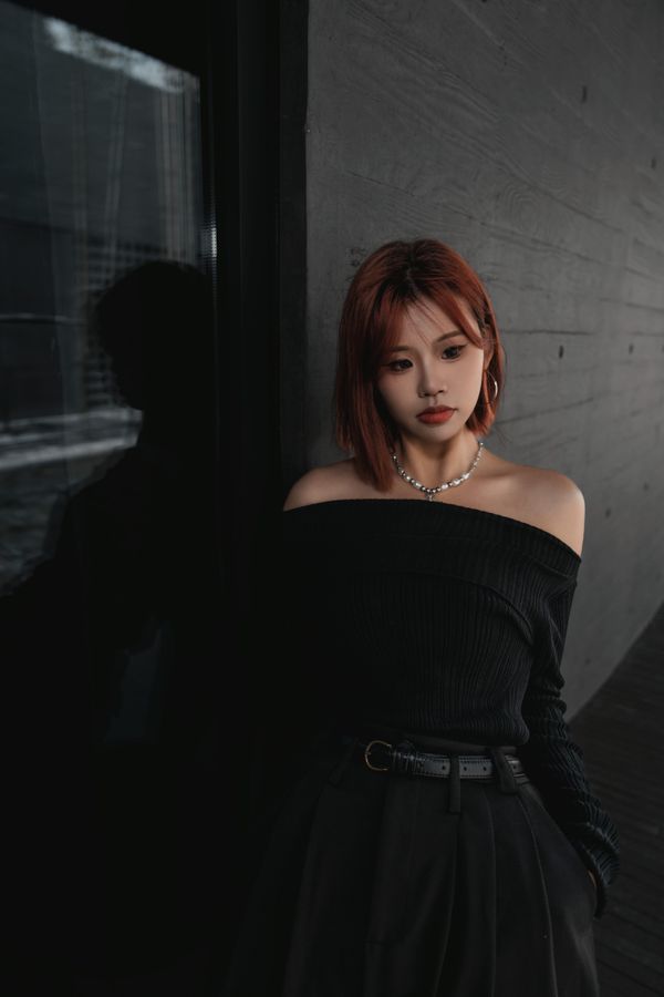Woman in off shoulder black top with skirt